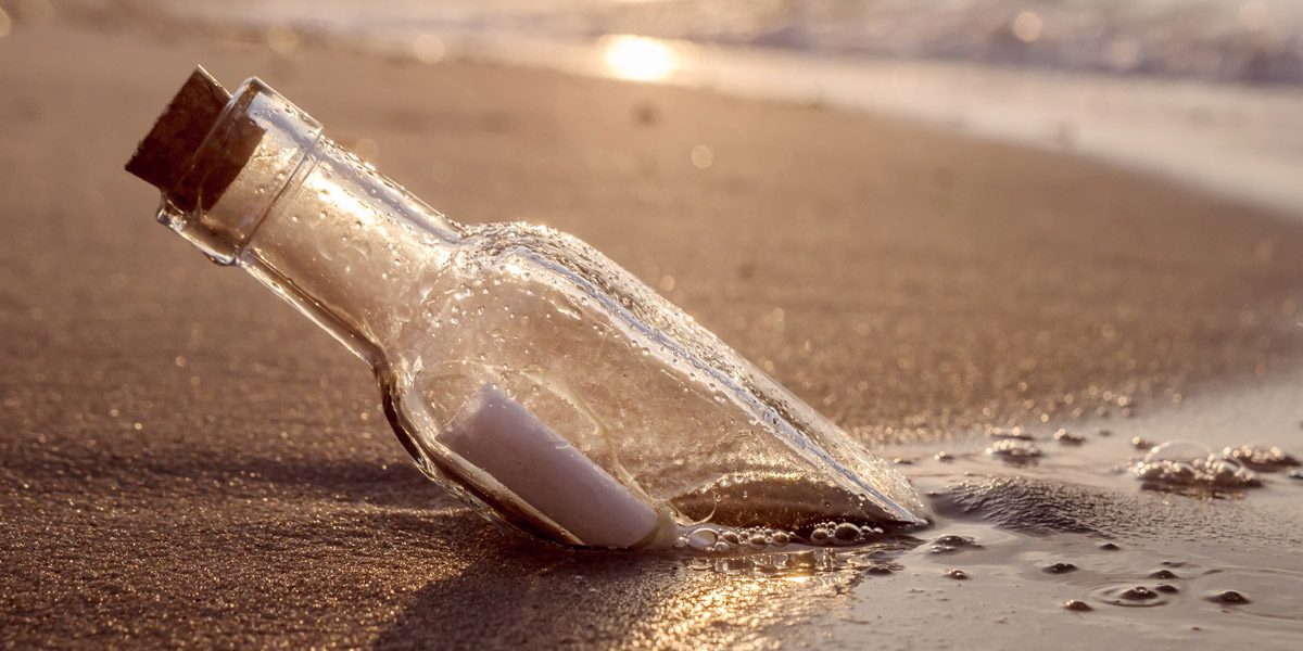 Message in a bottle on a sandy beach